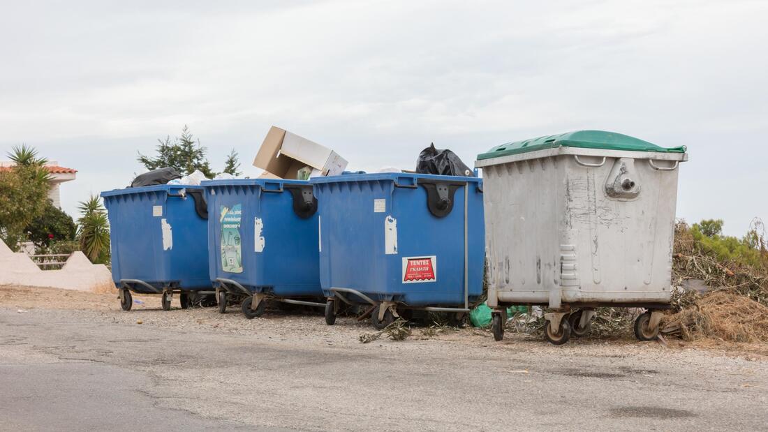 a four blue dumpster